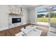 Spacious living room features a marble fireplace and sliding glass doors leading to the backyard at 4566 Ashtons Way, Franklinton, NC 27525