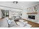Open living room with a view into the kitchen and a marble fireplace at 4566 Ashtons Way, Franklinton, NC 27525