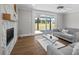 Living room with hardwood floors, fireplace, and view of the backyard at 4566 Ashtons Way, Franklinton, NC 27525