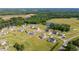 Aerial view of a large community with houses, roads, and a lake at 4566 Ashtons Way, Franklinton, NC 27525