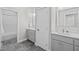 Double vanity bathroom with grey cabinets and a shower/tub combo at 4566 Ashtons Way, Franklinton, NC 27525