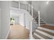 Modern staircase with metal railing in a bright entryway at 4566 Ashtons Way, Franklinton, NC 27525