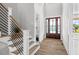 Bright entryway with hardwood floors and modern staircase at 4566 Ashtons Way, Franklinton, NC 27525