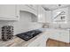 Closeup of kitchen gas cooktop and spice rack at 4566 Ashtons Way, Franklinton, NC 27525