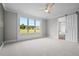 Main bedroom with large window, sliding barn door, and carpet flooring at 4566 Ashtons Way, Franklinton, NC 27525