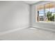 Well-lit bedroom featuring a large window and carpet flooring at 4566 Ashtons Way, Franklinton, NC 27525