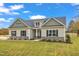 One-story home with stone accents and a neatly landscaped lawn at 30 Barham Mill Pond Ln, Wendell, NC 27591