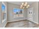 Bright dining room featuring hardwood floors, large windows, and a modern chandelier at 30 Barham Mill Pond Ln, Wendell, NC 27591