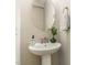 Modern powder room with pedestal sink, oval mirror, and stylish decor at 1329 Endgame Ct, Wake Forest, NC 27587