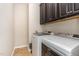 Convenient laundry room with washer, dryer, and dark brown cabinets at 1329 Endgame Ct, Wake Forest, NC 27587