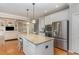 Kitchen with granite island, stainless steel appliances and hardwood floors at 1329 Endgame Ct, Wake Forest, NC 27587