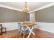Bright dining room featuring hardwood floors and elegant chandelier at 1329 Endgame Ct, Wake Forest, NC 27587