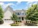 Two-story home with a large front porch and attached garage at 1329 Endgame Ct, Wake Forest, NC 27587