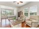 Relaxing sitting area with two armchairs and a coffee table, open to the main bedroom at 1329 Endgame Ct, Wake Forest, NC 27587