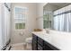 Clean bathroom with dark vanity, window, and shower/tub combo at 1329 Endgame Ct, Wake Forest, NC 27587