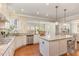 Spacious kitchen with an island, white cabinets, and hardwood floors at 1329 Endgame Ct, Wake Forest, NC 27587