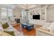 Open living room with hardwood floors, fireplace, and coffered ceiling at 1329 Endgame Ct, Wake Forest, NC 27587