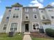 Three-story townhome with gray siding and a small front yard at 320 Gilman Ln # 110, Raleigh, NC 27610