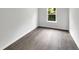 Spacious bedroom featuring grey vinyl flooring and a window at 320 Gilman Ln # 110, Raleigh, NC 27610