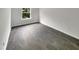 Bright bedroom with grey vinyl flooring and a large window at 320 Gilman Ln # 110, Raleigh, NC 27610