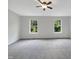 Spacious bedroom with neutral carpeting and large windows at 320 Gilman Ln # 110, Raleigh, NC 27610