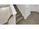 Carpeted staircase with wooden handrail at 320 Gilman Ln # 110, Raleigh, NC 27610