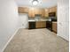 Efficient kitchen with wood cabinets and tile floor at 320 Gilman Ln # 110, Raleigh, NC 27610
