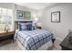 Cozy bedroom with a plaid comforter and soccer-themed decor at 8805 Tartan Clan Dr, Willow Springs, NC 27592
