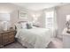 Spacious bedroom with light and airy decor, featuring a queen bed and wooden nightstands at 8805 Tartan Clan Dr, Willow Springs, NC 27592