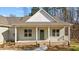 Close-up of a charming front porch with a green door, brick accents, and inviting entryway at 95 Leisure Ln, Louisburg, NC 27549