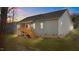 Backyard of a home with deck, stairs, and grass at dusk at 95 Leisure Ln, Louisburg, NC 27549