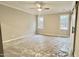 Spacious bedroom with neutral walls, ceiling fan, and barn door at 106 Wichita Way, Louisburg, NC 27549