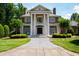 Impressive two-story home with a grand entrance, brick facade, and manicured landscaping at 1820 Oatlands Court Ct, Wake Forest, NC 27587