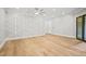 Bright bedroom with hardwood floors, ceiling fan and sliding glass doors at 111 November Dr, Durham, NC 27712