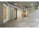 Covered patio features a stone floor, access from multiple doors, and ceiling fan at 111 November Dr, Durham, NC 27712
