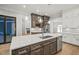 Large kitchen island with white quartz countertops and dark cabinets at 111 November Dr, Durham, NC 27712