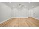 Spacious bedroom with hardwood floors, ceiling fan, and geometric accent wall at 111 November Dr, Durham, NC 27712