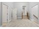 Spacious hallway with carpet, stairs, and multiple doors at 111 November Dr, Durham, NC 27712