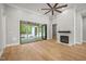 Bright living room with hardwood floors, fireplace, and access to a spacious patio at 111 November Dr, Durham, NC 27712