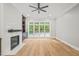 Bright living room featuring hardwood floors, a fireplace, and large windows at 111 November Dr, Durham, NC 27712