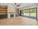 Living room with hardwood floors, stone fireplace, and folding glass doors to patio at 109 November Dr, Durham, NC 27712