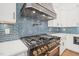 Upscale kitchen features gas range, pot filler, and custom range hood at 109 November Dr, Durham, NC 27712