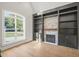 Spacious living room with a stone fireplace and built-in shelving at 109 November Dr, Durham, NC 27712