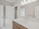 Modern bathroom with vanity, mirror, and white tile flooring at 109 November Dr, Durham, NC 27712