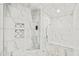 Large walk-in shower with marble tile and built-in seat at 109 November Dr, Durham, NC 27712