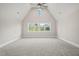 Spacious bedroom with vaulted ceiling, carpet, and multiple windows at 109 November Dr, Durham, NC 27712