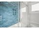 Bathroom with blue tile shower and a clear glass enclosure at 109 November Dr, Durham, NC 27712