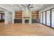 Bright living room with hardwood floors, a stone fireplace, and access to a patio at 109 November Dr, Durham, NC 27712