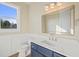 Stylish bathroom with navy vanity, gold fixtures, and patterned wallpaper at 109 November Dr, Durham, NC 27712