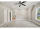 Bright bedroom featuring a ceiling fan and grey carpet at 109 November Dr, Durham, NC 27712